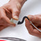 Someone repairing a cord with sugru