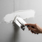 someone using a throwel to apply a filler on a wall