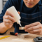 create an image of someone gluing a piece of wood