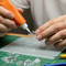 create an image of someone gluing a piece of plastic