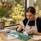 A crafter uses Glues Australia's Dries Clear glue to create a detailed paper sculpture in a sunlit workshop, showcasing the adhesive's invisible bond