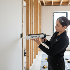 A person successfully repairing a large wall crack in their modern Australian home using High Gap Fill adhesive. This DIY home improvement image showcases an easy and effective solution for wall repairs