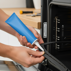 A person fixing the oven gasket with a silicone from Glues Australia