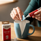 A lifestyle image of a person's hands fixing a broken ceramic mug with 'Fast Set' glue. The packaging with the words 'Glues Australia' is visible next to it.