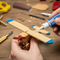 Close-up of hands applying Glues Australia Instant Bond adhesive to a wooden craft, showcasing fast and strong adhesion for DIY projects and repairs. Perfect for hobbyists seeking reliable, quick-drying glue for model making and home improvements