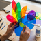 A creator in a modern studio crafting a vibrant acrylic sculpture, using Glues Australia's clear-drying acrylic glue. This lifestyle image for the 'Acrylics' collection showcases creativity and high-quality crafting supplies