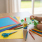 Lifestyle image for Glues Australia's Craft & School collection, featuring a child's hands crafting with glue, scissors, and colorful paper on a wooden desk, perfect for school and home projects.