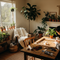 A lifestyle image for Glues Australia's 'Indoor Only' collection, showing a person using the product to craft a wooden picture frame in a sunlit, cozy living room