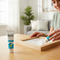 Lifestyle image for Glues Australia's Instant Fix collection. A person is easily and quickly repairing a wooden picture frame, showcasing the product's fast and effective adhesive properties in a modern home setting