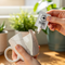 a person's hands using a Glues Australia Single-Use Pack to repair a broken ceramic mug at home