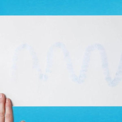 Bostik Blu Stik being applied to paper, showing the blue glue trail